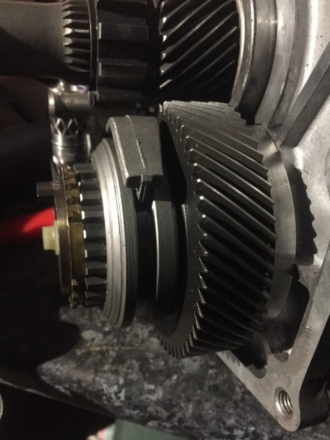 See that shiny steel bhind the big 5th overdrive gear..thats the new steel support for the contersshaft bearing... shims under it tyo set counter shaft end float/preload
