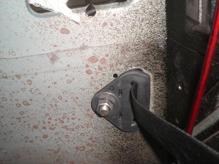 Buckle mounted under speaker shelf